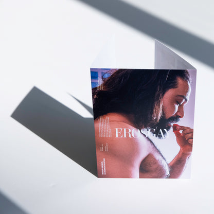 Empaque del Sixpack de Arturo de ErosGay, en vista frontal; portada a color con retrato de perfil de un hombre de cabello largo sosteniendo un pétalo rojo cerca de la boca, con el logotipo “EROSGAY” centrado.